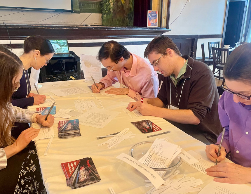 Volunteers writing postcards to Target executives, telling them to get the corporation to fulfill their cage-free promise