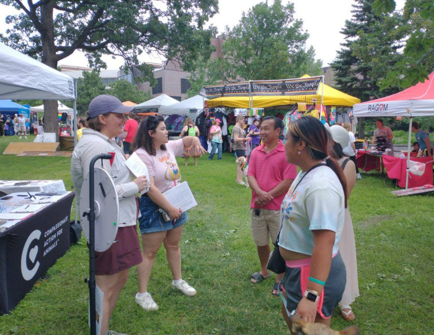 Hannah and another volunteer lead outreach for animals at Twin Cities Pride